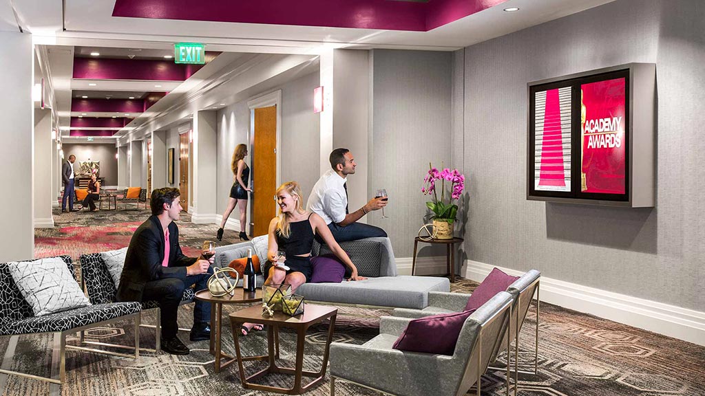 A group of people sitting on a couch in a room.