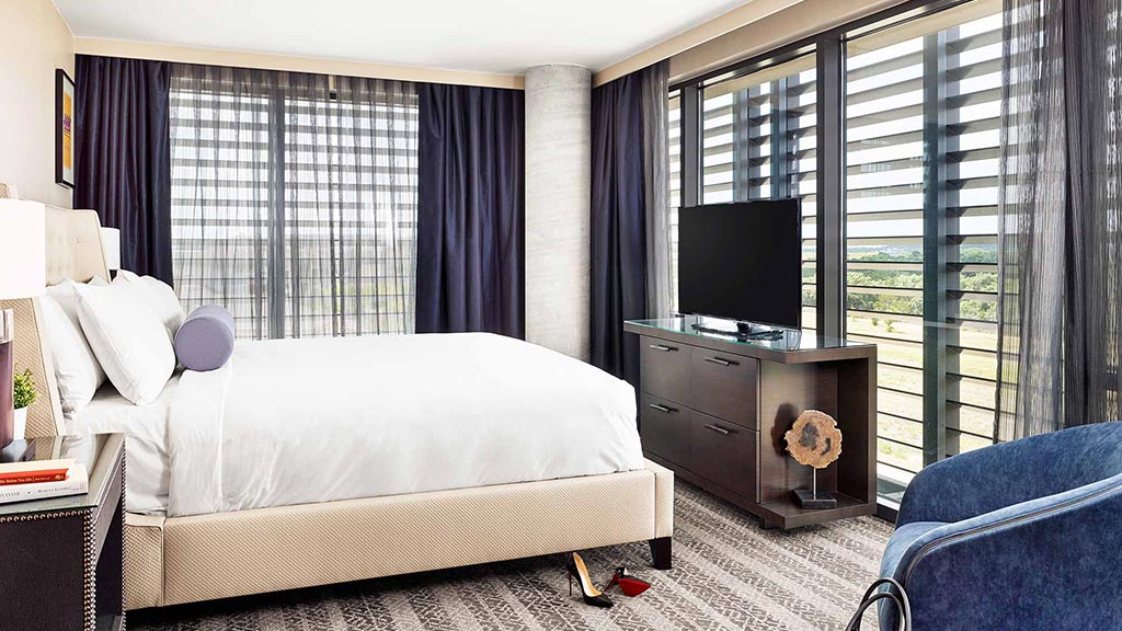 A bedroom with a bed and a tv.