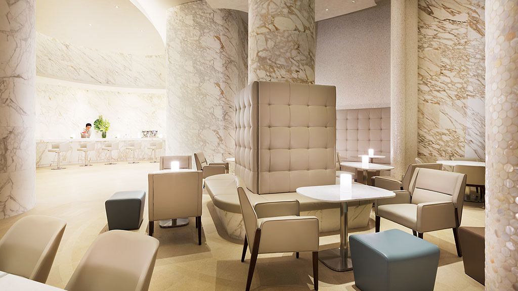 A room with a table chairs and a white wall.