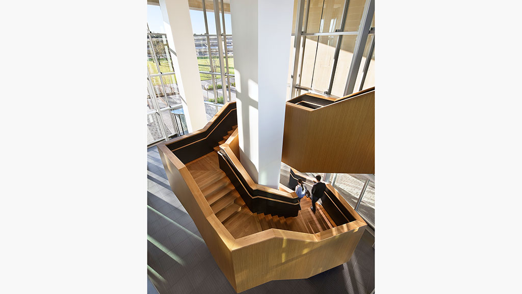 A couple of people walking up a flight of stairs.