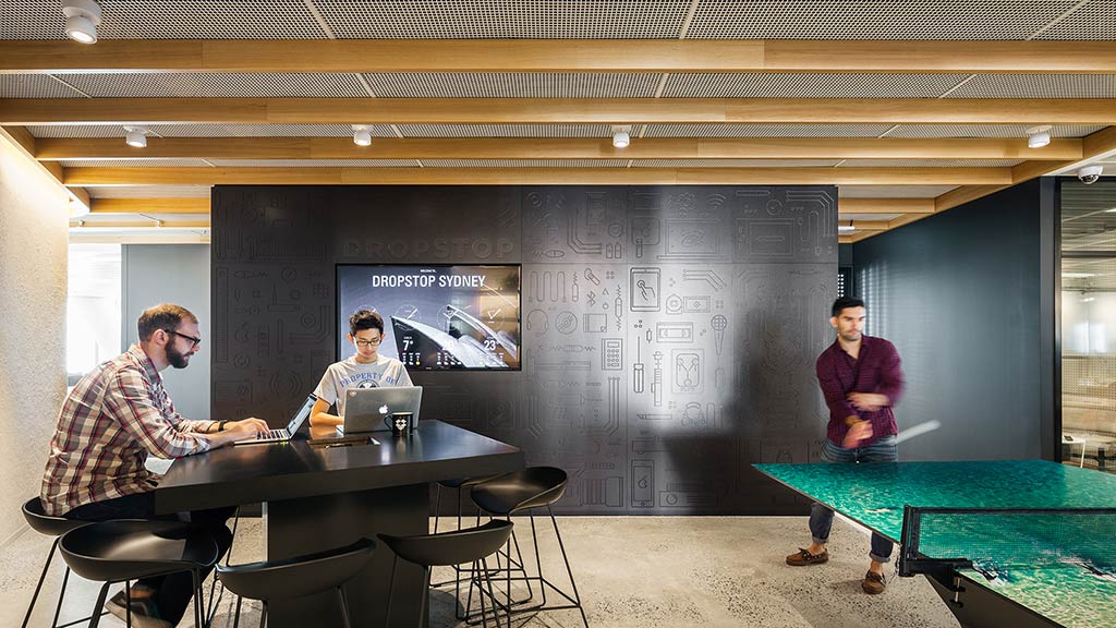 A few men playing ping pong.