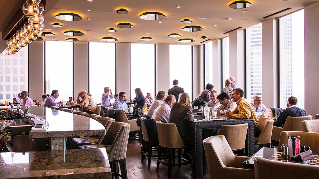 A group of people sitting at tables.