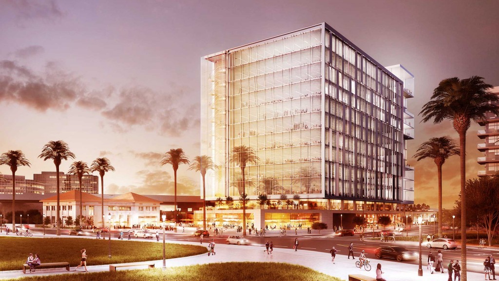 A large glass building with people walking around.