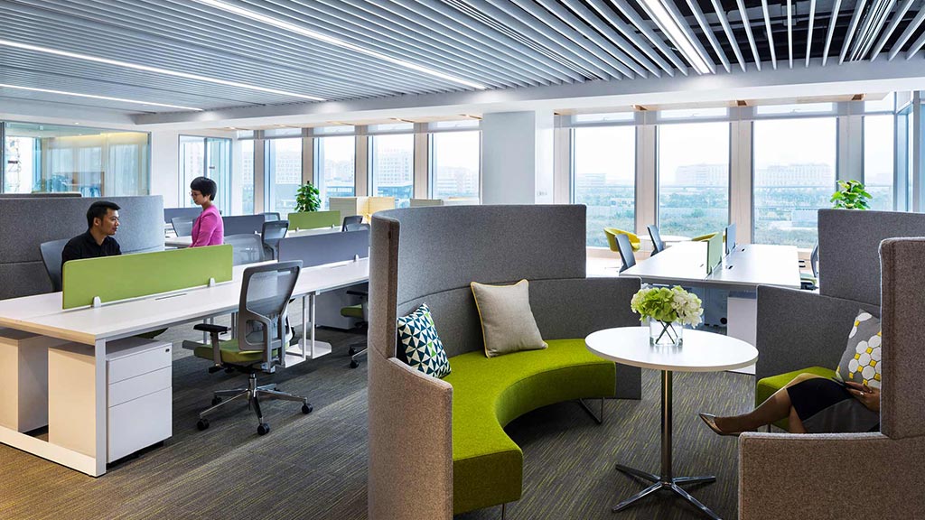 A room with a table chairs and a couple of women.