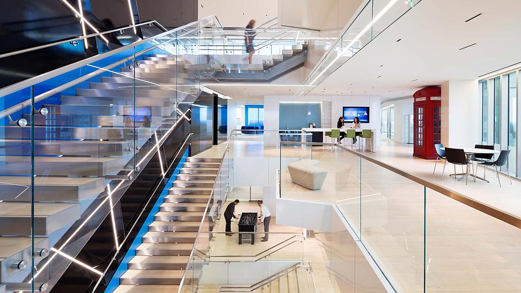 A long hallway with people and computers.