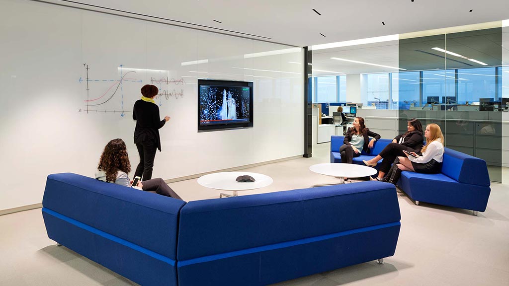 A group of people watching a television.