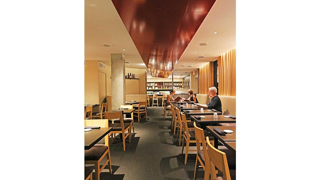 People sitting at tables in a restaurant.