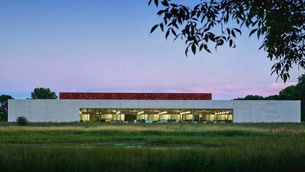 A building with a grass field in front of it.