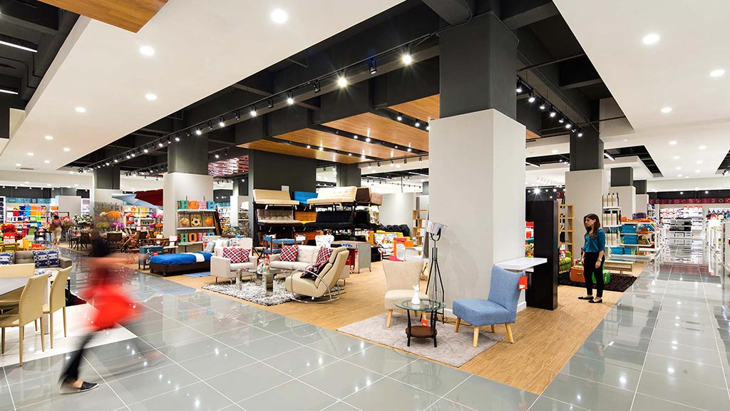 A large room with a few people.