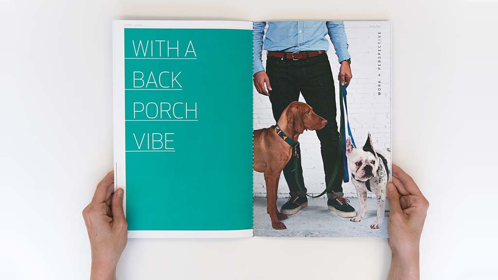 A person holding a book with a dog and a dog on it.