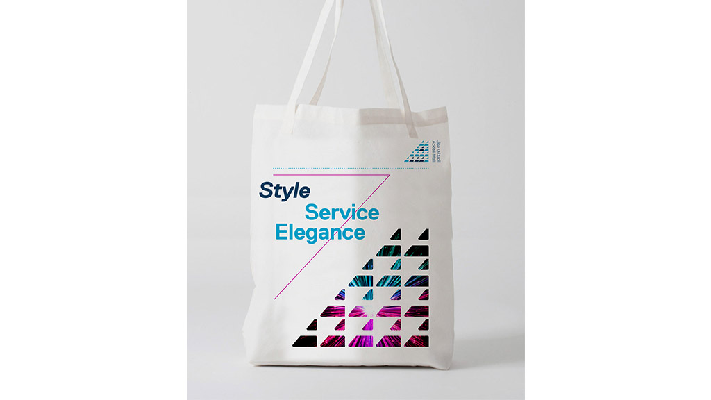 A white bag with a pink and blue label.