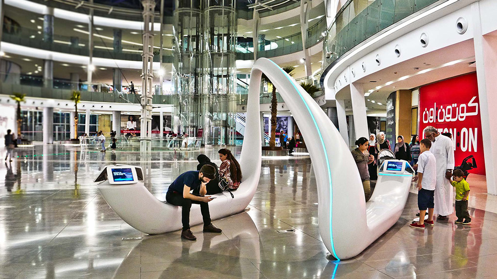 People around a large white sculpture.
