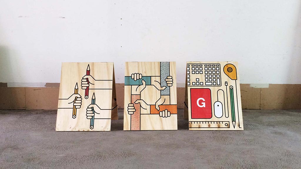 A group of boxes with drawings on them with Cadillac Ranch in the background.