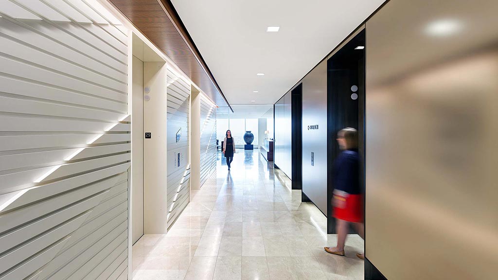 People walking down a hallway.
