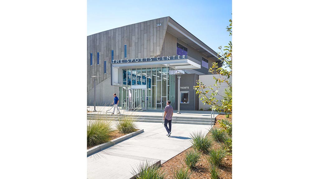 A few men walking outside of a building.