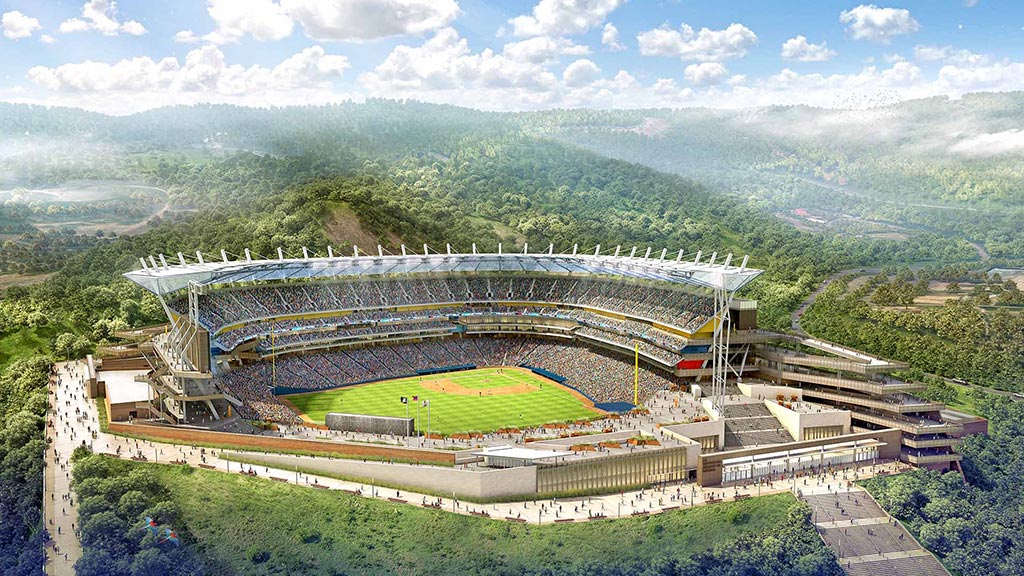A large stadium with a field and trees in the background.