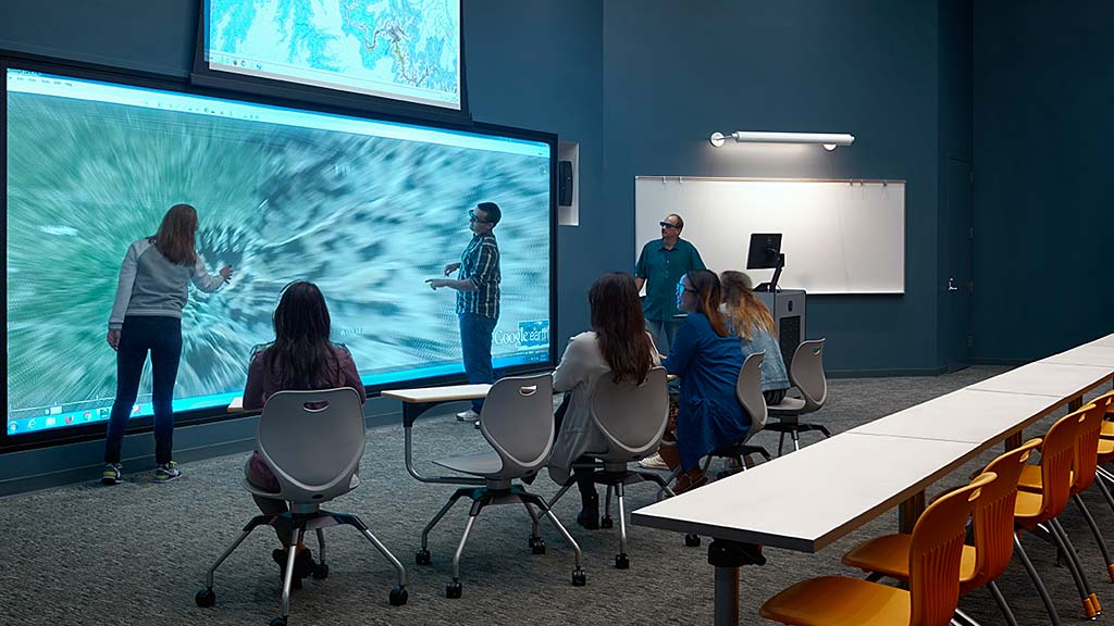 A group of people watching a presentation.
