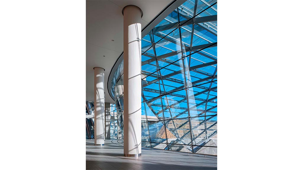 A large glass building with a large glass window.