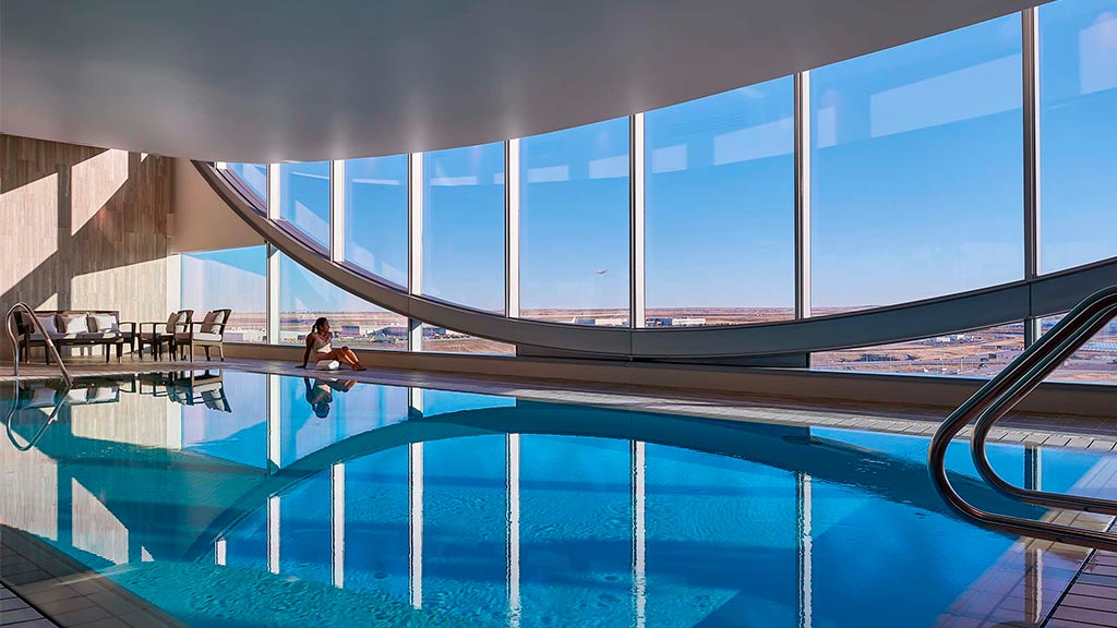 A person jumping into a pool.