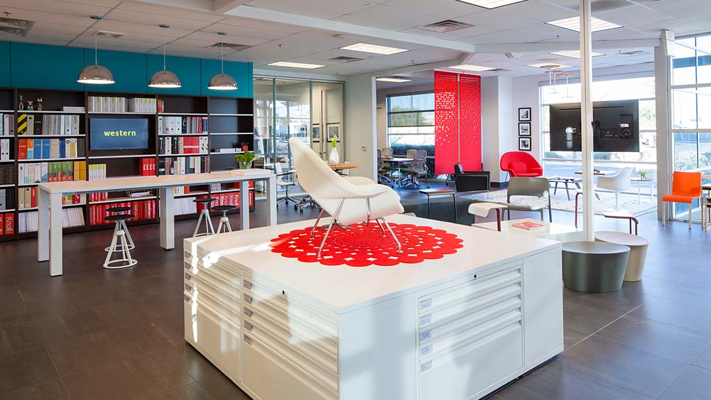 A library with a large white table.