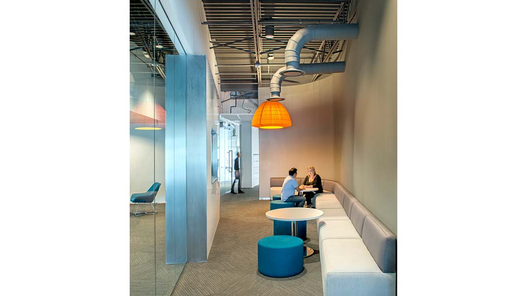 A couple of people sitting at a table in a building.