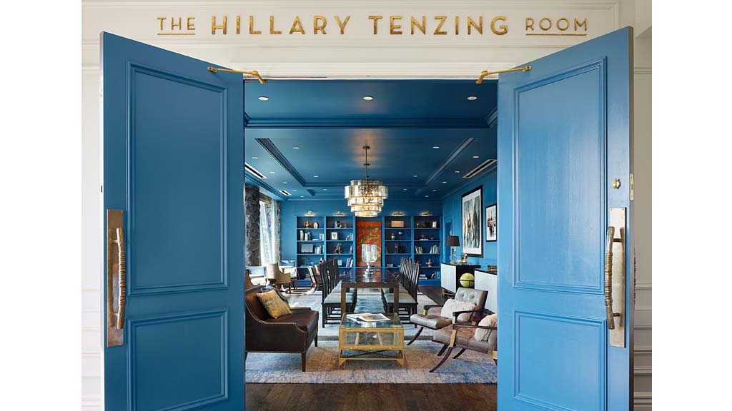 A living room with blue doors.