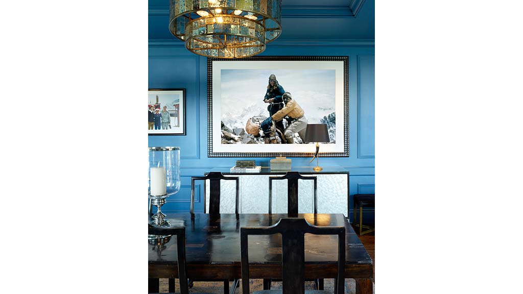 A table with a painting on the wall.