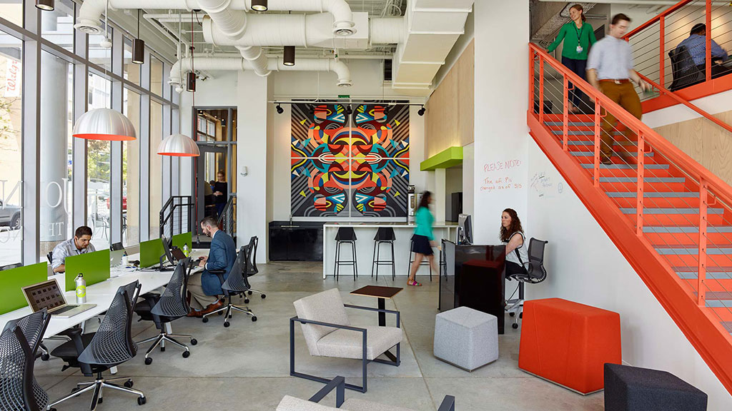 People in a room with tables and chairs.