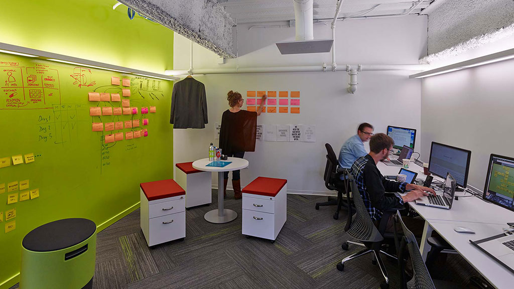 A group of people sitting at computers.