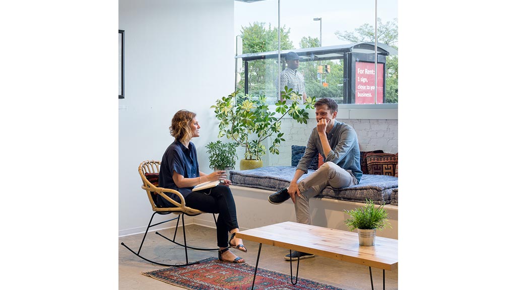 A man and a woman sitting on a couch.