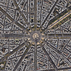 A satellite view of Paris city blocks with the Arc de Triomphe in the center.