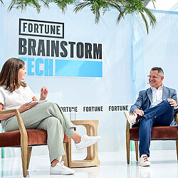 A man and a woman sitting on chairs.