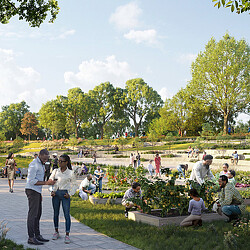 A group of people sitting on a bench in a park.