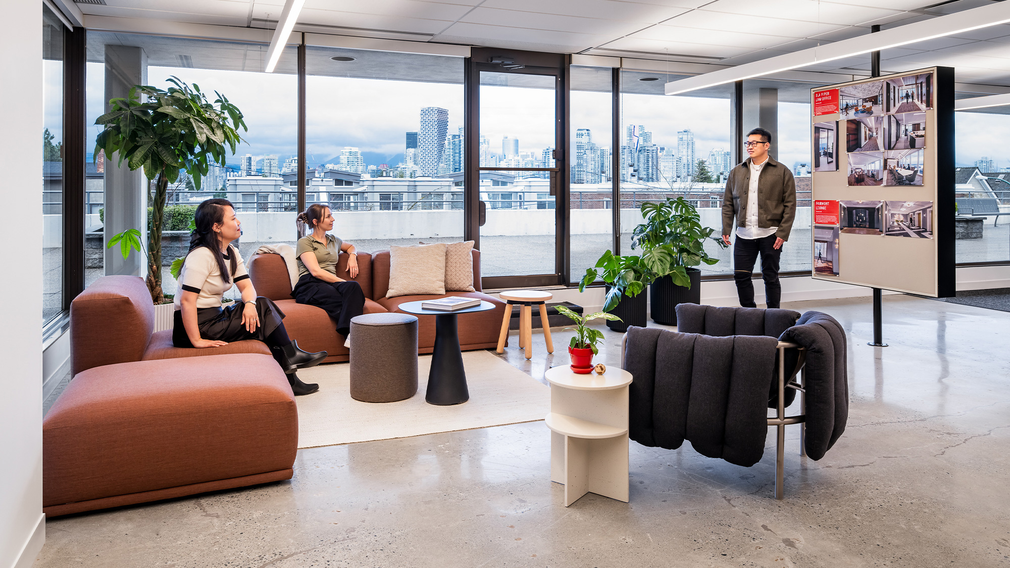A group of people sitting in chairs in a room with a large window.