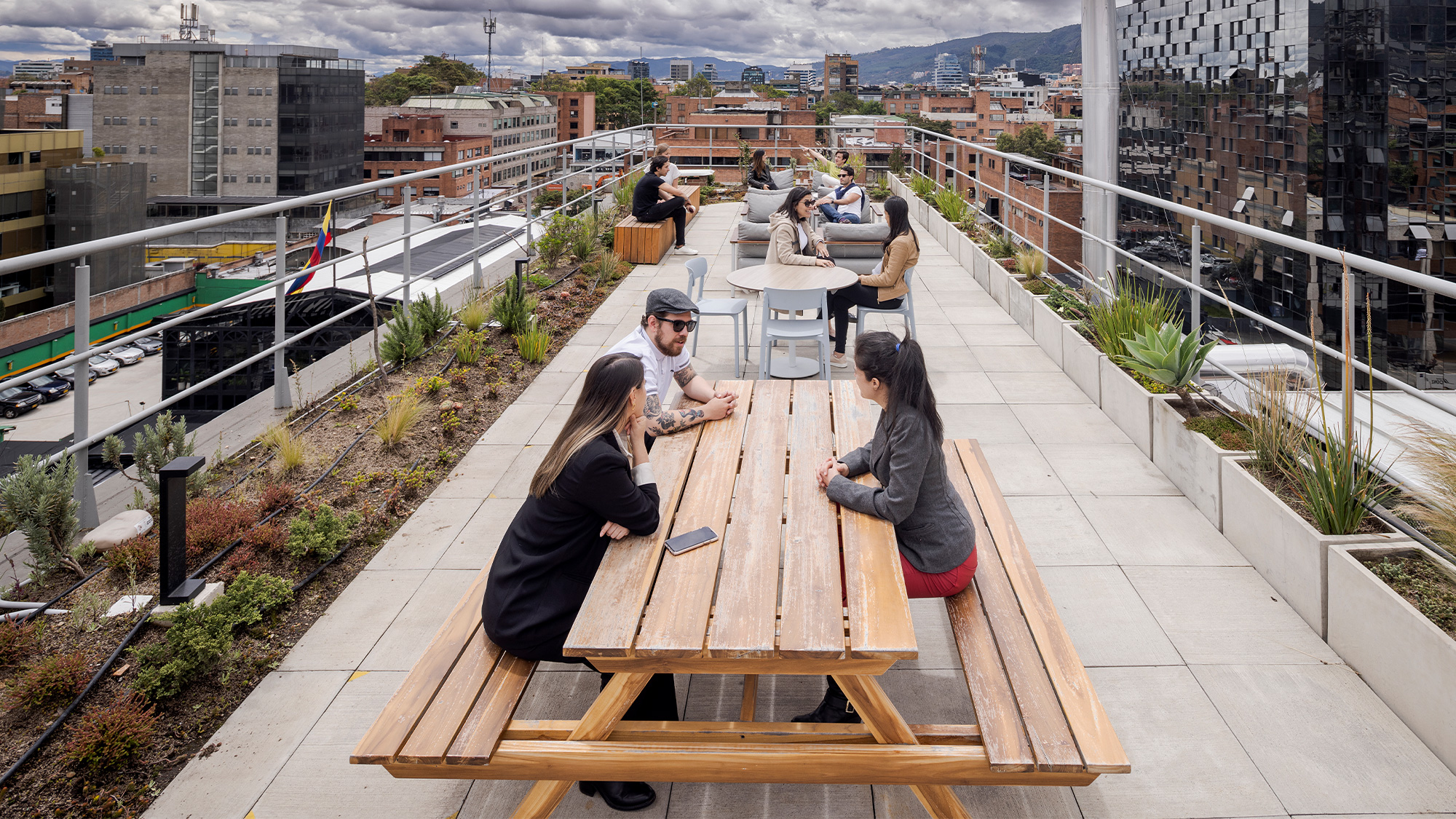 A group of people sitting at a table outside.