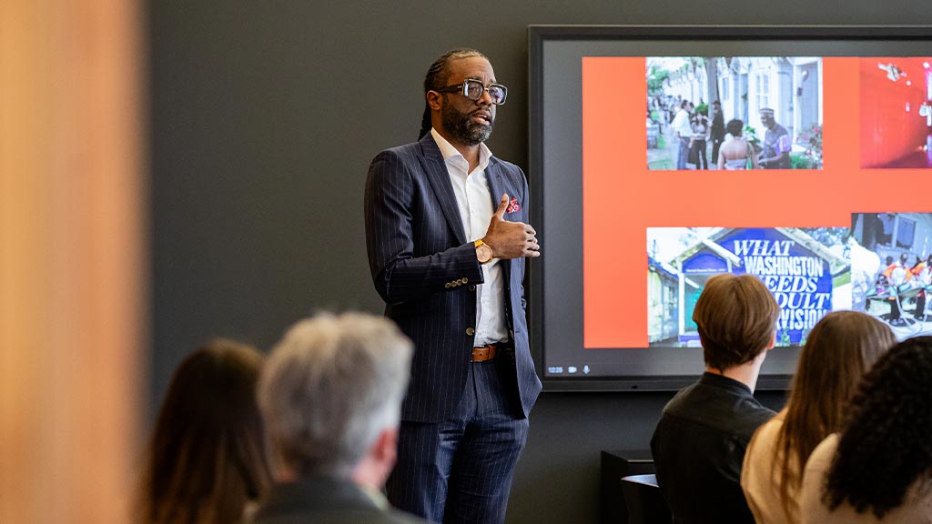 A person speaking to a group of people.