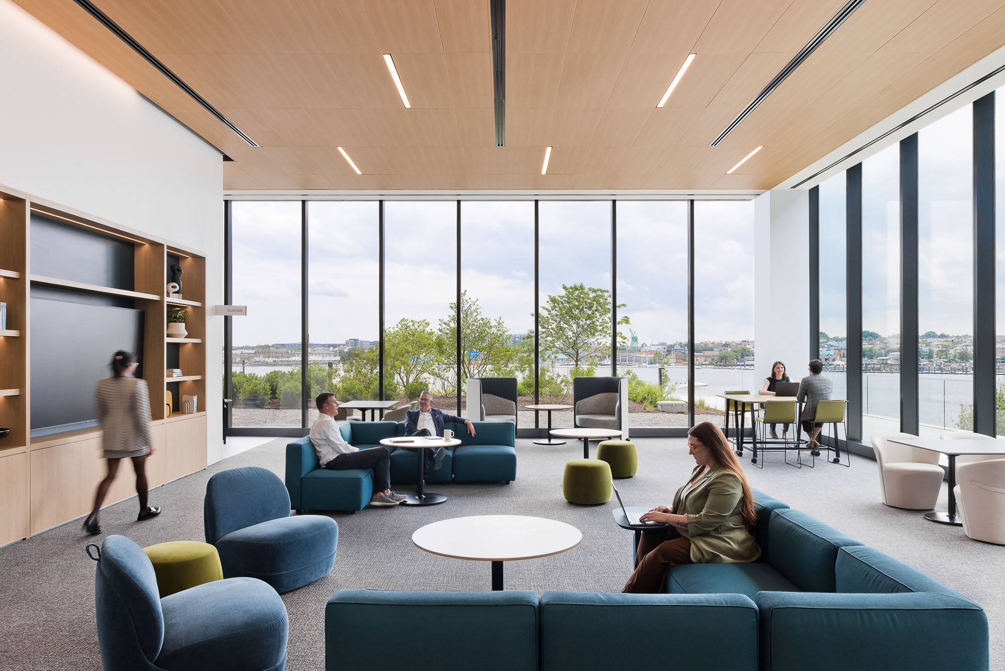 A group of people in a room with large windows.