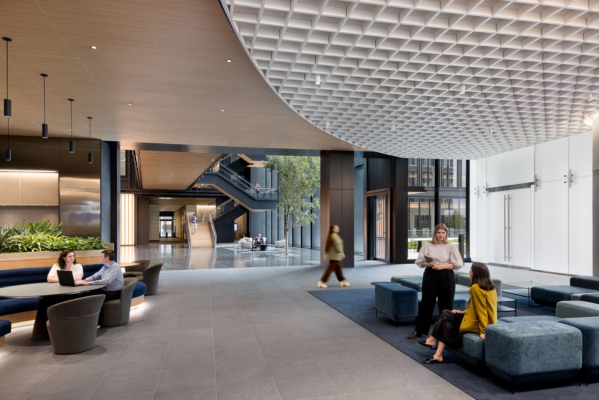 People sitting on benches in a building.