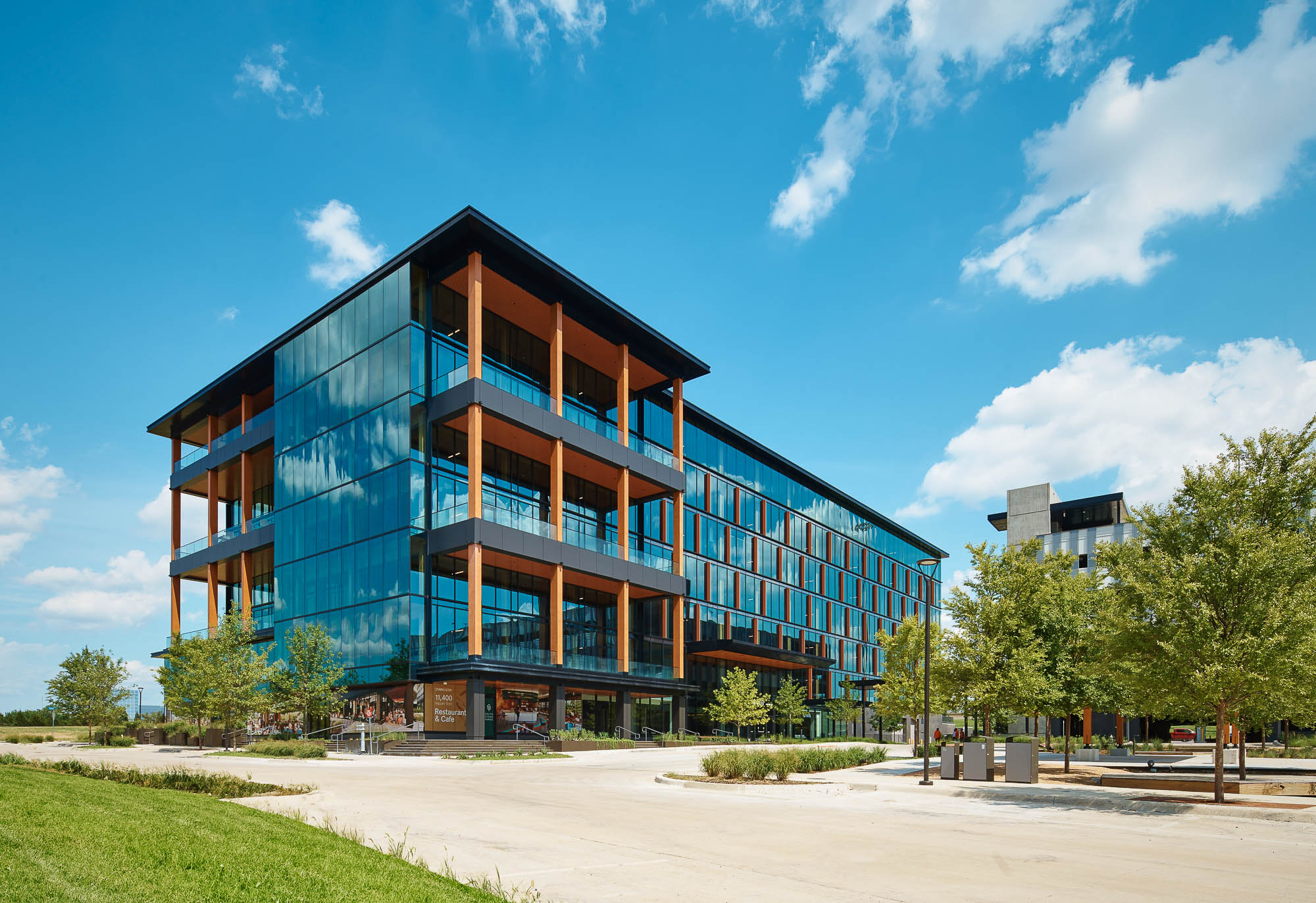 A building with a walkway and trees.