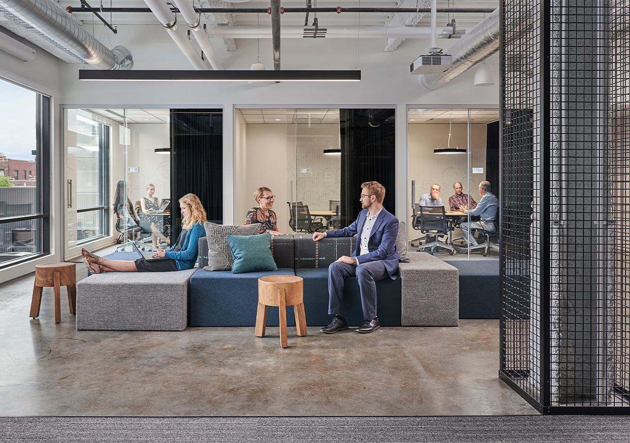 A group of people sitting on a couch in a room.