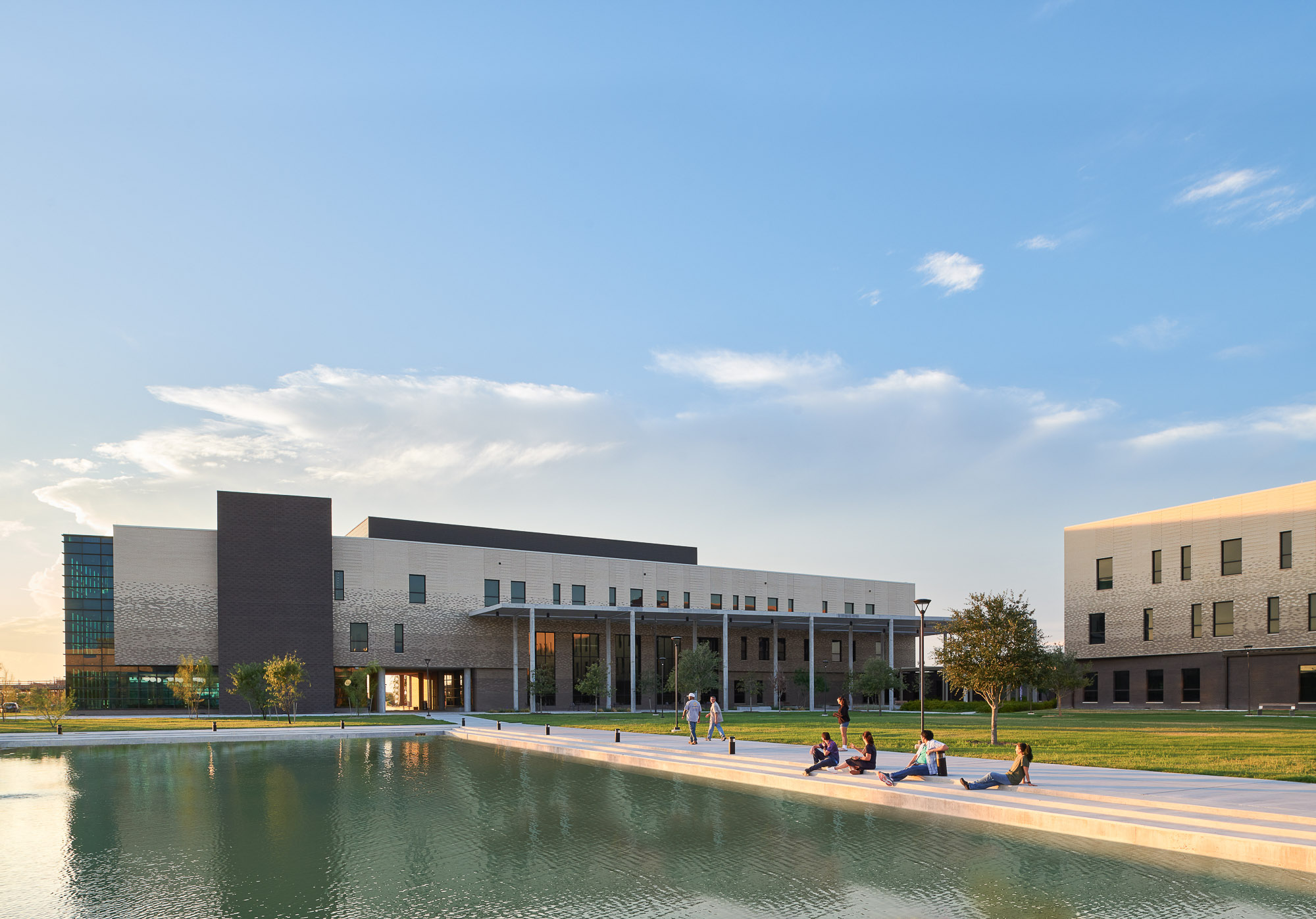 A building with a pond in front of it.