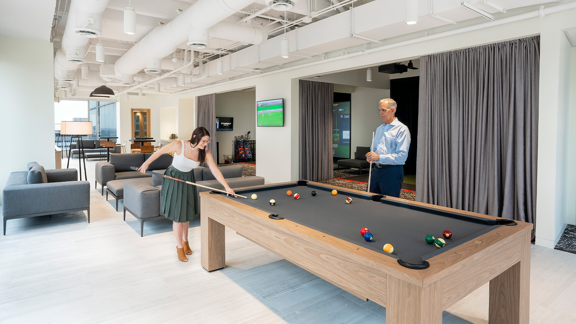 A man and a woman playing pool.