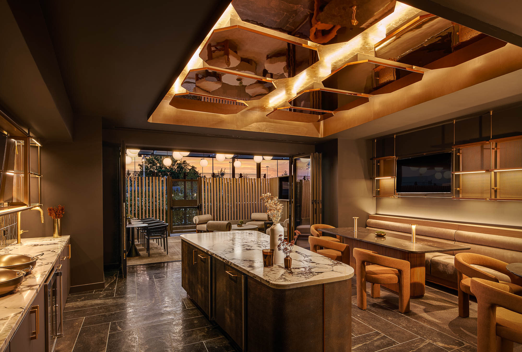 A large kitchen with a bar and chairs.