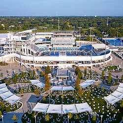 A large building with a pool and trees around it.