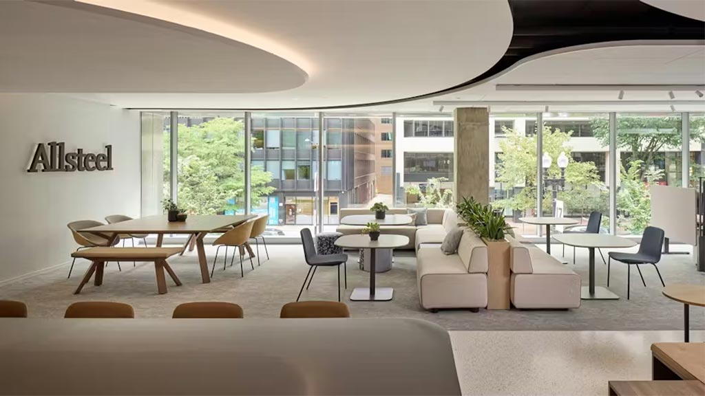A room with a couch and chairs.