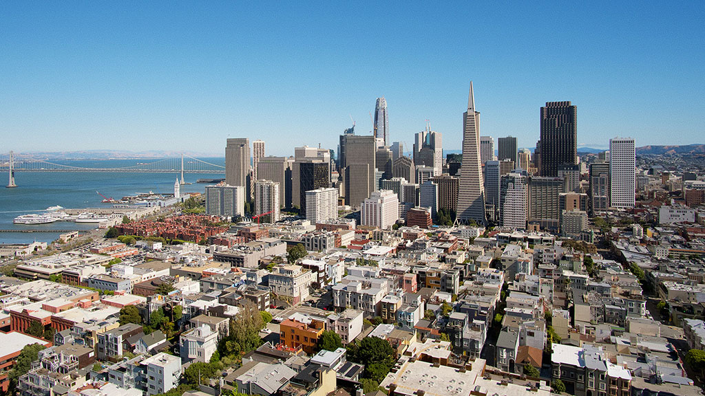 A city with tall buildings by the water.