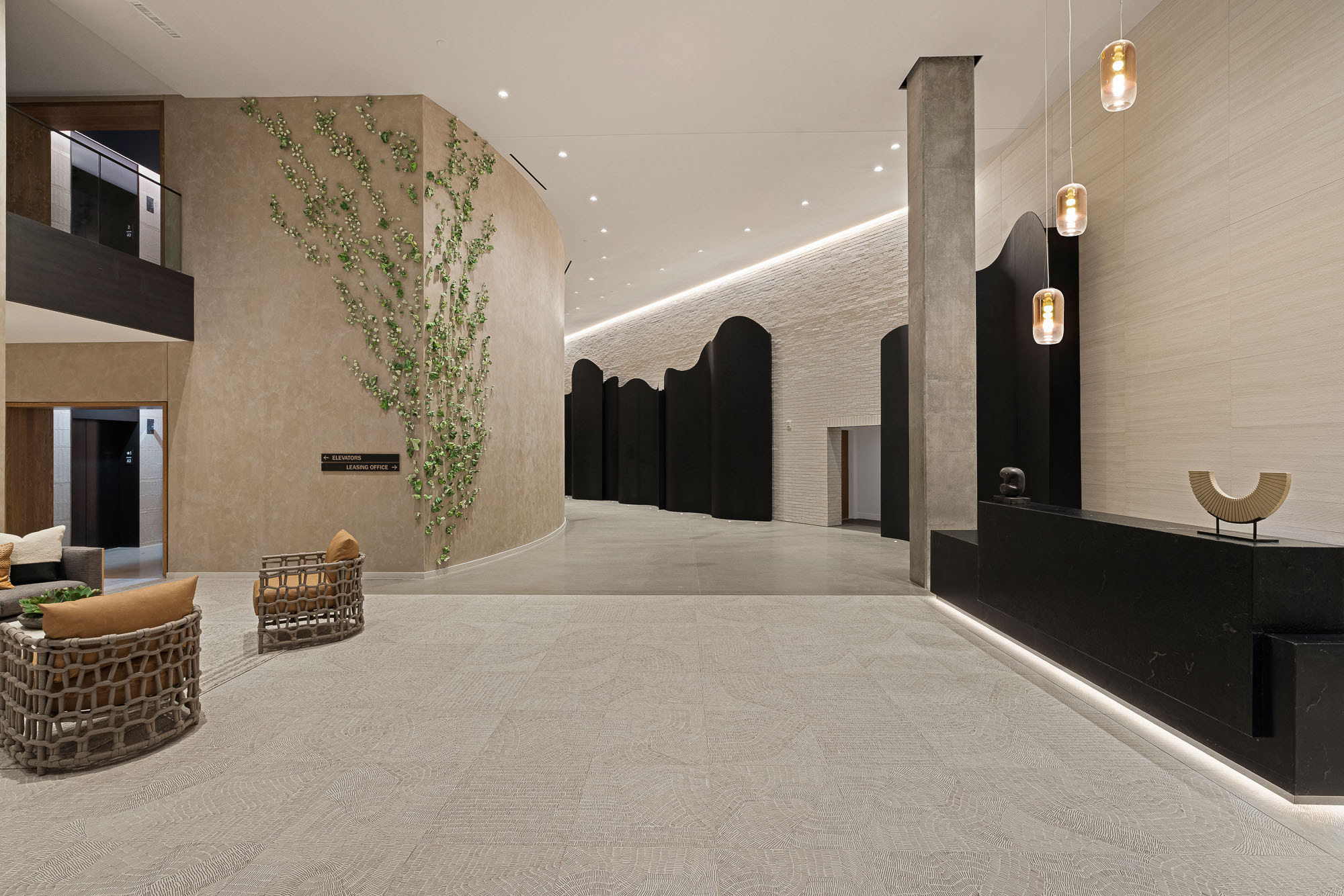 A large room with a large stone wall and a large tree.