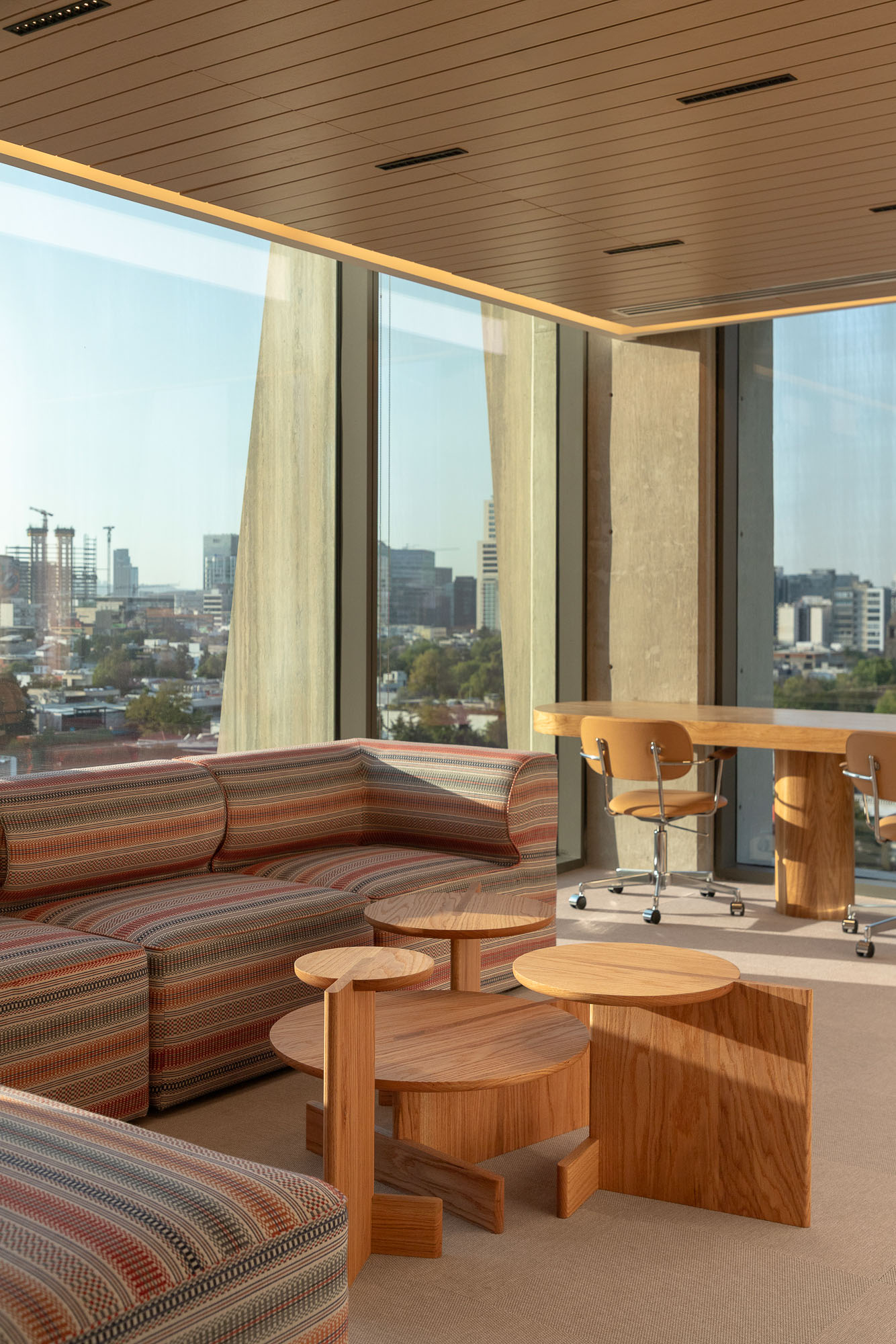 A room with a large window and a table with chairs in it.