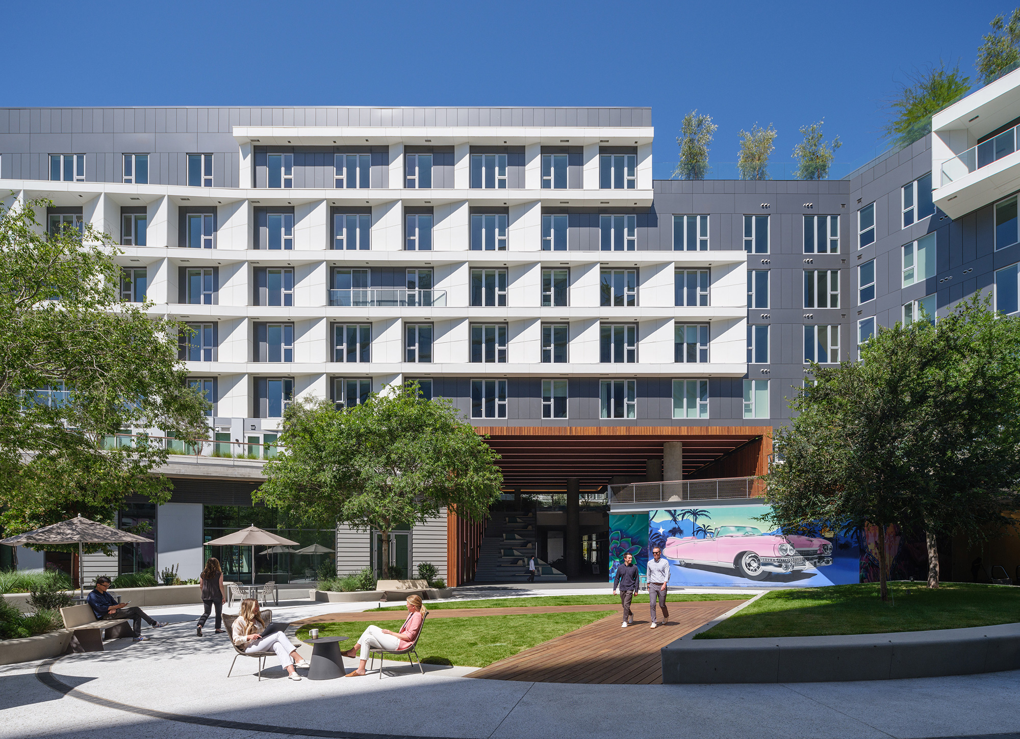 A building with many windows and people walking around.