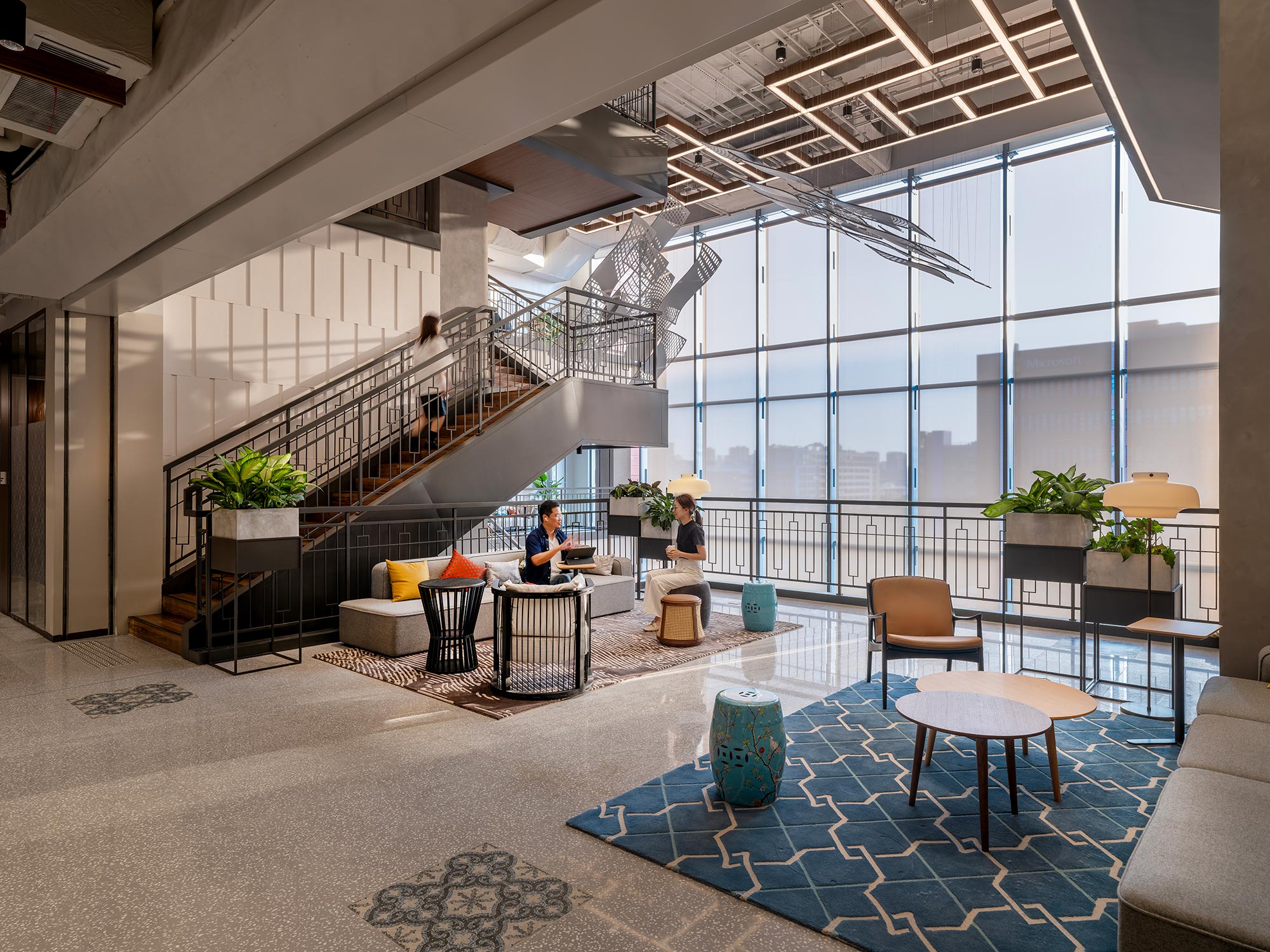 A room with a staircase and tables.